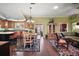 Open floor plan with kitchen, dining area, and living room with hardwood floors at 215 Chula Vista Ave, The Villages, FL 32159