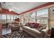Bright sunroom with hardwood floors, vaulted ceiling, and large windows at 215 Chula Vista Ave, The Villages, FL 32159