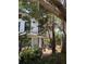 Side of home with access to a deck under a covered area that is shared by two units at 220 E Woodward Ave, Eustis, FL 32726