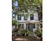 Front exterior of a multi-Gathering home with a shared entrance surrounded by many potted plants at 220 E Woodward Ave, Eustis, FL 32726