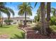 Expansive backyard featuring a covered patio and lush tropical landscaping at 2312 Nackman Pl, The Villages, FL 32162