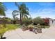 Picturesque backyard with a charming patio area, lovely plantings, and tropical landscaping at 2312 Nackman Pl, The Villages, FL 32162