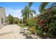 Relaxing backyard with a patio, lush vegetation, and a cozy seating area surrounded by vibrant plants and flowers at 2312 Nackman Pl, The Villages, FL 32162