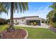 Expansive backyard patio area with room for seating, grilling and entertaining and a screened-in porch at 2312 Nackman Pl, The Villages, FL 32162