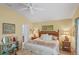 Tranquil bedroom with neutral tones, comfortable furnishings, and an ensuite bathroom for added convenience at 2312 Nackman Pl, The Villages, FL 32162