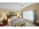 Serene bedroom with vaulted ceilings, soft lighting, and a view of sheer curtains and windows at 2312 Nackman Pl, The Villages, FL 32162