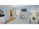 A cozy bedroom with blue walls, comfortable bedding, and a doorway leading to another room at 2312 Nackman Pl, The Villages, FL 32162