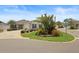 Charming single-story home featuring a well-manicured lawn and lush landscaping at 2312 Nackman Pl, The Villages, FL 32162