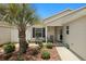 Charming home with a quaint front porch with rocking chairs and beautifully maintained landscaping at 2312 Nackman Pl, The Villages, FL 32162