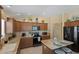 Modern kitchen featuring stainless steel appliances, a central island, and plenty of cabinet space for storage at 2312 Nackman Pl, The Villages, FL 32162
