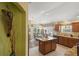 Well-equipped kitchen with stainless steel appliances, granite countertops, and a central island with breakfast bar at 2312 Nackman Pl, The Villages, FL 32162