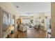 Bright living room featuring hardwood floors, neutral decor, and large windows at 2312 Nackman Pl, The Villages, FL 32162