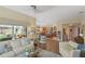 Bright living space with open floor plan, access to lanai, and seamless flow to the kitchen area at 2312 Nackman Pl, The Villages, FL 32162
