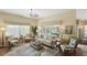 Bright and airy living room with hardwood floors, neutral decor, and large windows at 2312 Nackman Pl, The Villages, FL 32162