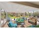 Spacious lanai with comfortable seating and views of the landscaped backyard at 2312 Nackman Pl, The Villages, FL 32162