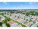 An aerial view displays lush landscaping and charming single-story homes in a vibrant residential community near the waterfront at 2317 Whisper St, The Villages, FL 32162