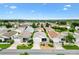 An aerial view showcases the beautiful neighborhood with well-maintained homes at 2317 Whisper St, The Villages, FL 32162