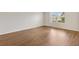 Bedroom with wood flooring and a large window at 2317 Whisper St, The Villages, FL 32162