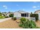 Charming home featuring a white picket fence, well-kept landscaping, and a welcoming exterior at 2317 Whisper St, The Villages, FL 32162