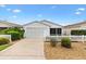 Charming home featuring a white picket fence and well-kept landscaping at 2317 Whisper St, The Villages, FL 32162