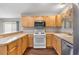 Kitchen featuring light wood cabinetry and modern appliances at 2317 Whisper St, The Villages, FL 32162