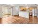 Open-concept kitchen with stainless steel appliances and wood cabinets at 2317 Whisper St, The Villages, FL 32162