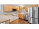 Kitchen with light wood cabinetry and stainless-steel refrigerator at 2317 Whisper St, The Villages, FL 32162