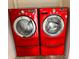 Modern laundry room featuring matching red LG washer and dryer appliances at 2317 Whisper St, The Villages, FL 32162