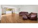 Bright living room with wood flooring open to the kitchen at 2317 Whisper St, The Villages, FL 32162
