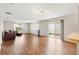 Spacious living room with wood flooring, large windows, and sliding glass doors to the backyard at 2317 Whisper St, The Villages, FL 32162