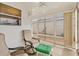 Screened porch with ceiling fan, chairs and ottomans and natural light at 2317 Whisper St, The Villages, FL 32162