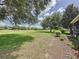 Expansive backyard showcasing the serene green space and mature trees, offering privacy and scenic views at 243 Bayou Bend Rd, Groveland, FL 34736