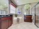 Bathroom features double sinks, a soaking tub with tile surround, tile flooring, and walk-in shower at 243 Bayou Bend Rd, Groveland, FL 34736