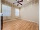 An airy bedroom with wood floors, detailed trim, and windows at 243 Bayou Bend Rd, Groveland, FL 34736