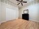 Bedroom featuring wood flooring, a ceiling fan, and a closet at 243 Bayou Bend Rd, Groveland, FL 34736