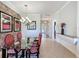 Elegant dining room with modern lighting, textured wall, and a view into the entryway at 243 Bayou Bend Rd, Groveland, FL 34736
