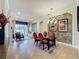 Dining room with a glass table, adjacent sitting area, and neutral decor at 243 Bayou Bend Rd, Groveland, FL 34736