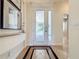 Elegant foyer featuring decorative tile flooring, a glass-paneled front door, and stylish decor at 243 Bayou Bend Rd, Groveland, FL 34736