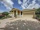 Inviting front exterior of a home with a brick driveway, attached garage, and a covered porch at 243 Bayou Bend Rd, Groveland, FL 34736