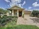 Charming single-Gathering home featuring a well-manicured lawn and a welcoming brick pathway to the front door at 243 Bayou Bend Rd, Groveland, FL 34736