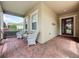 Charming covered front porch with seating, offering a relaxing outdoor space near the main entrance at 243 Bayou Bend Rd, Groveland, FL 34736