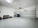 Spacious garage with overhead storage and plenty of room for multiple vehicles at 243 Bayou Bend Rd, Groveland, FL 34736