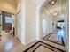 Bright hallway with tile flooring, arched doorways, and access to a bathroom and other living spaces at 243 Bayou Bend Rd, Groveland, FL 34736