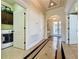 Spacious hallway with tiled floors, archways, and access to the laundry room and front entrance at 243 Bayou Bend Rd, Groveland, FL 34736