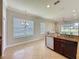 Bright eat-in kitchen has a sink with granite countertops, tile flooring, and view to a living area at 243 Bayou Bend Rd, Groveland, FL 34736