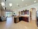 Open-concept kitchen and living area with a stainless steel dishwasher and view of the backyard at 243 Bayou Bend Rd, Groveland, FL 34736