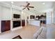 Open-concept living room with a fireplace, flat-screen TV, and seamless flow to the kitchen at 243 Bayou Bend Rd, Groveland, FL 34736