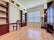 Bright office space with wooden built-in desks and cabinets and plenty of natural light at 243 Bayou Bend Rd, Groveland, FL 34736