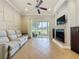 Comfortable living room with a fireplace, large sliding glass door, and neutral color scheme at 243 Bayou Bend Rd, Groveland, FL 34736