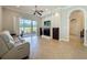 Inviting living room with a fireplace, sliding glass door, and neutral decor at 243 Bayou Bend Rd, Groveland, FL 34736
